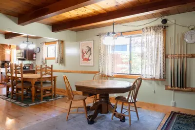 a dining room with a wooden table and chairs at Fern Grove - Hot Tub, Pet Friendly, Walk to Lake! in Tahoe City