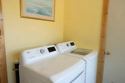 a washer and dryer in a laundry room at Fern Grove - Hot Tub, Pet Friendly, Walk to Lake! in Tahoe City