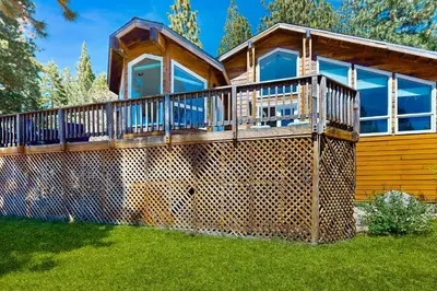 a house with a large deck on the front of it at Livin' Lake Life in Incline Village