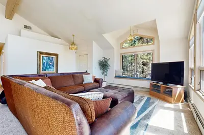 a living room with couches and a flat screen tv at Livin' Lake Life in Incline Village