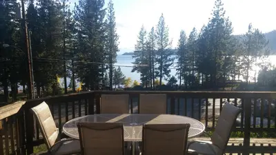 a table and chairs on a balcony with a view of a lake at Livin' Lake Life in Incline Village