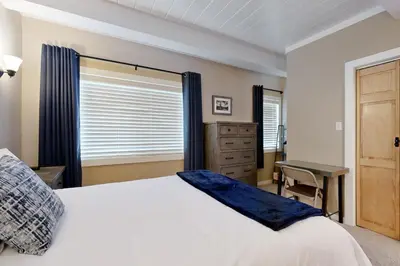 a bedroom with a bed and a desk and a window at Alpine Serenity in Incline Village