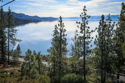 a view of a lake with trees in the foreground at Alpine Serenity in Incline Village