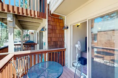 a porch with a glass table on a balcony at Alpine Serenity in Incline Village