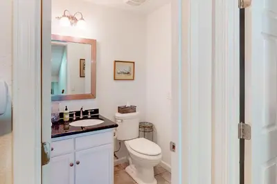 a bathroom with a toilet and a sink and a mirror at Under The Stars in Shaver Lake