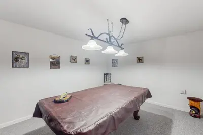 a bedroom with a bed in a room with pictures on the wall at Under The Stars in Shaver Lake