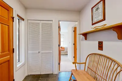 a hallway with a wooden bench next to a door at McCloud 176 in Incline Village
