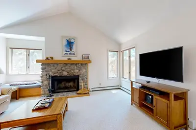 a living room with a fireplace and a flat screen tv at McCloud 176 in Incline Village