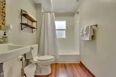 a bathroom with a toilet and a sink and a tub at Camp Cocktail - Cabin in the Heart of the Sierra, Arnold, CA in Arnold
