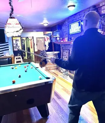 a man standing in front of a pool table at Camp Cocktail - Cabin in the Heart of the Sierra, Arnold, CA in Arnold