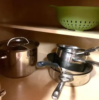 two pots and pans sitting on a kitchen counter at Camp Cocktail - Cabin in the Heart of the Sierra, Arnold, CA in Arnold