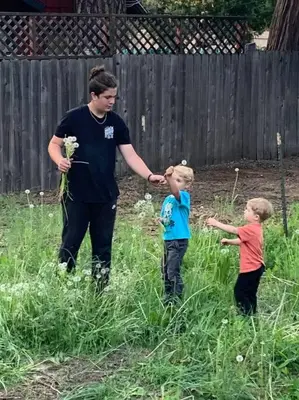 a man and two boys standing in the grass at Camp Cocktail - Cabin in the Heart of the Sierra, Arnold, CA in Arnold