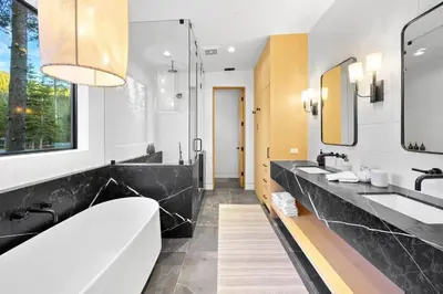 a bathroom with two sinks and a large mirror at Creekside Retreat - Near Palisades Tahoe in Olympic Valley