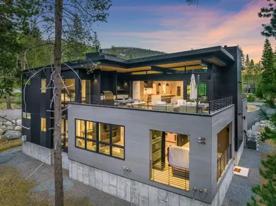 a contemporary house with a view of the backyard at Creekside Retreat - Near Palisades Tahoe in Olympic Valley