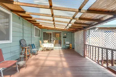 a wooden deck with awning on a house at Auburn Cottage with Patios and Garden - 3 Mi to Town! in Auburn