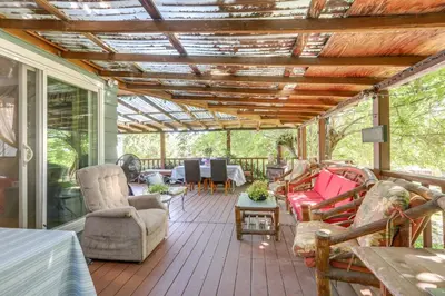 a screened in porch with furniture and a ceiling at Auburn Cottage with Patios and Garden - 3 Mi to Town! in Auburn