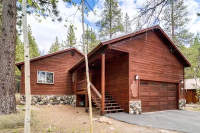 a large wooden cabin with a garage at Home with Deck and Access to Tahoe Donner Amenities! in Truckee