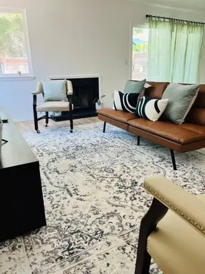 a living room with a couch and a fireplace at Remodeled Oasis in Visalia