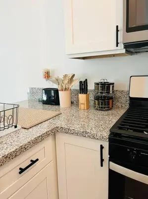 a kitchen with a stove and a counter top at Remodeled Oasis in Visalia