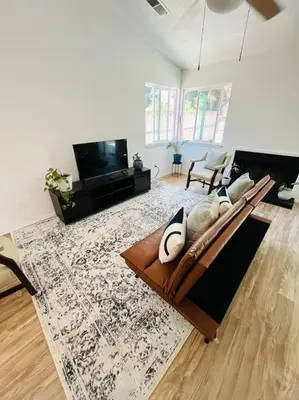 a living room with a couch and a television at Remodeled Oasis in Visalia