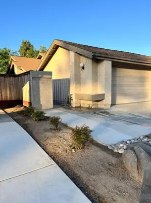 a house with a driveway and a garage at Remodeled Oasis in Visalia