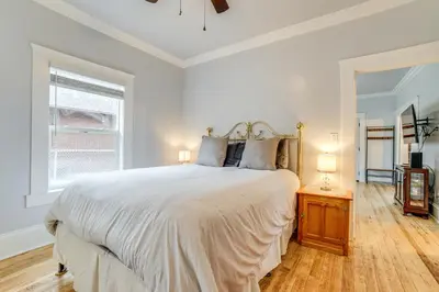 a white bedroom with a large bed and a window at Walk to Midtown Charming Reno Retreat in Reno