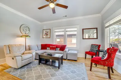a living room with a couch and red chairs at Walk to Midtown Charming Reno Retreat in Reno