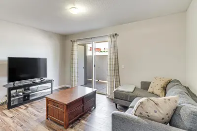 a living room with a couch and a tv at 3 Mi to Downtown Reno Charming Condo with Patio in Reno