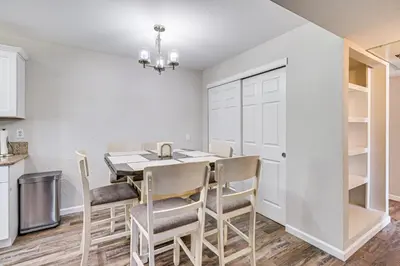 a kitchen and dining room with a table and chairs at 3 Mi to Downtown Reno Charming Condo with Patio in Reno