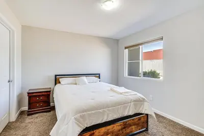 a bedroom with a bed and a window at 3 Mi to Downtown Reno Charming Condo with Patio in Reno
