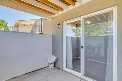 a house with a sliding glass door with a balcony at 3 Mi to Downtown Reno Charming Condo with Patio in Reno
