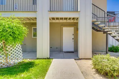 an empty building with a white door and stairs at 3 Mi to Downtown Reno Charming Condo with Patio in Reno
