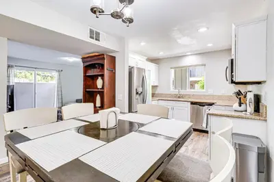 a kitchen with a table and chairs in a room at 3 Mi to Downtown Reno Charming Condo with Patio in Reno