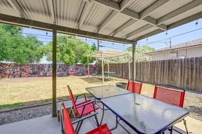 a patio with a table with chairs and an umbrella at Family-Friendly Clovis Home with Gas Grill and Patio! in Clovis