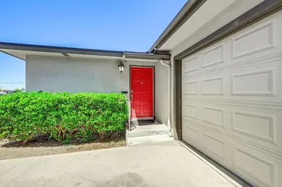 a garage with a red door in a house at Family-Friendly Clovis Home with Gas Grill and Patio! in Clovis