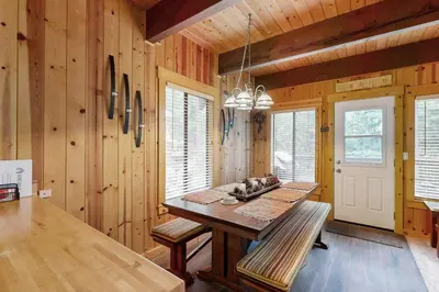 a dining room with a table and wooden walls at Tranquil Family Cabin in Incline Village