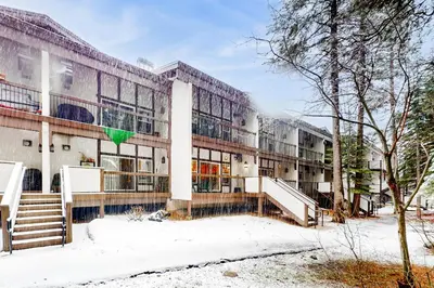 an office building with snow on the ground at Tavern Inn #38 in Olympic Valley