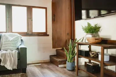 a living room with a chair and a table with plants at Redwood Grove in Sequoia and Kings Canyon National Park in Wilsonia