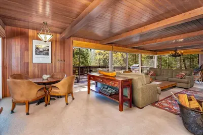 a living room with a wooden ceiling and a table and chairs at River's Edge w/ BBQ, Wifi, Firepit in North Wawona