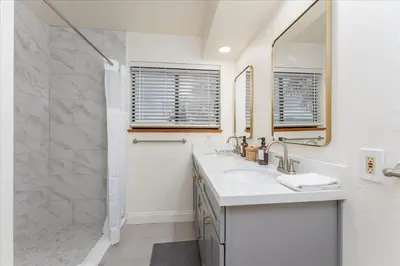 a bathroom with a sink and a shower at Vista Haven with stunning views/hot tub/mini golf in Oakhurst