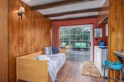 a bedroom with a bed and a large window at Bass Lake Chalet- A frame with hot tub/firepit in Oakhurst