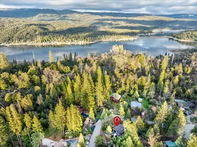 an aerial view of a lake and a house at Bass Lake Chalet- A frame with hot tub/firepit in Oakhurst