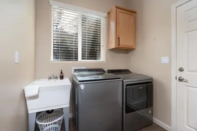 a small kitchen with a stove and a sink at Mountain View House with hot tub, putting green, stunning views in Oakhurst