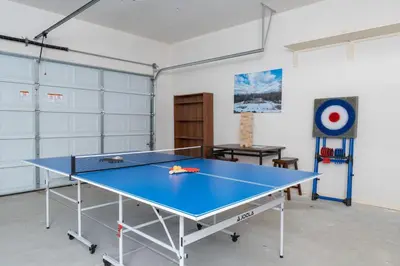 a room with a ping pong table in it at Mountain View House with hot tub, putting green, stunning views in Oakhurst