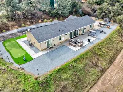 an overhead view of a large house with a patio at Mountain View House with hot tub, putting green, stunning views in Oakhurst