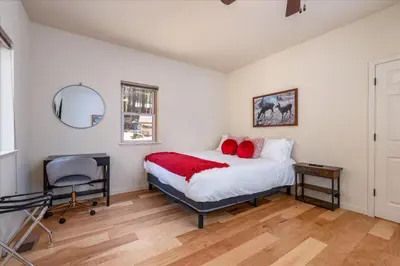 a bedroom with a bed and a desk and a chair at Base Camp- Inside Yose w pool table/grill in North Wawona