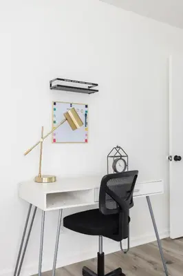 an office with a white desk and a black chair at Homey Pool Fun Gameroom Sunnyside Retreat in Fresno