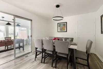 a dining room with a table and chairs at Homey Pool Fun Gameroom Sunnyside Retreat in Fresno