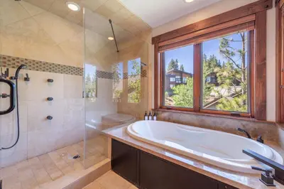 a large bathroom with a tub and a window at Luxury Northstar Home Walk to Lifts Private Hot-Tub Fenced-In Yard Book on Mobile for Promo Price in Truckee