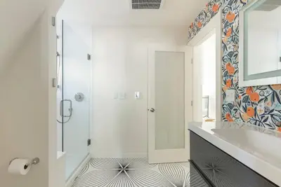 a white bathroom with a shower and a sink at Brand New Modern A-Frame In Kings Beach Two Blocks From The Beach in Kings Beach